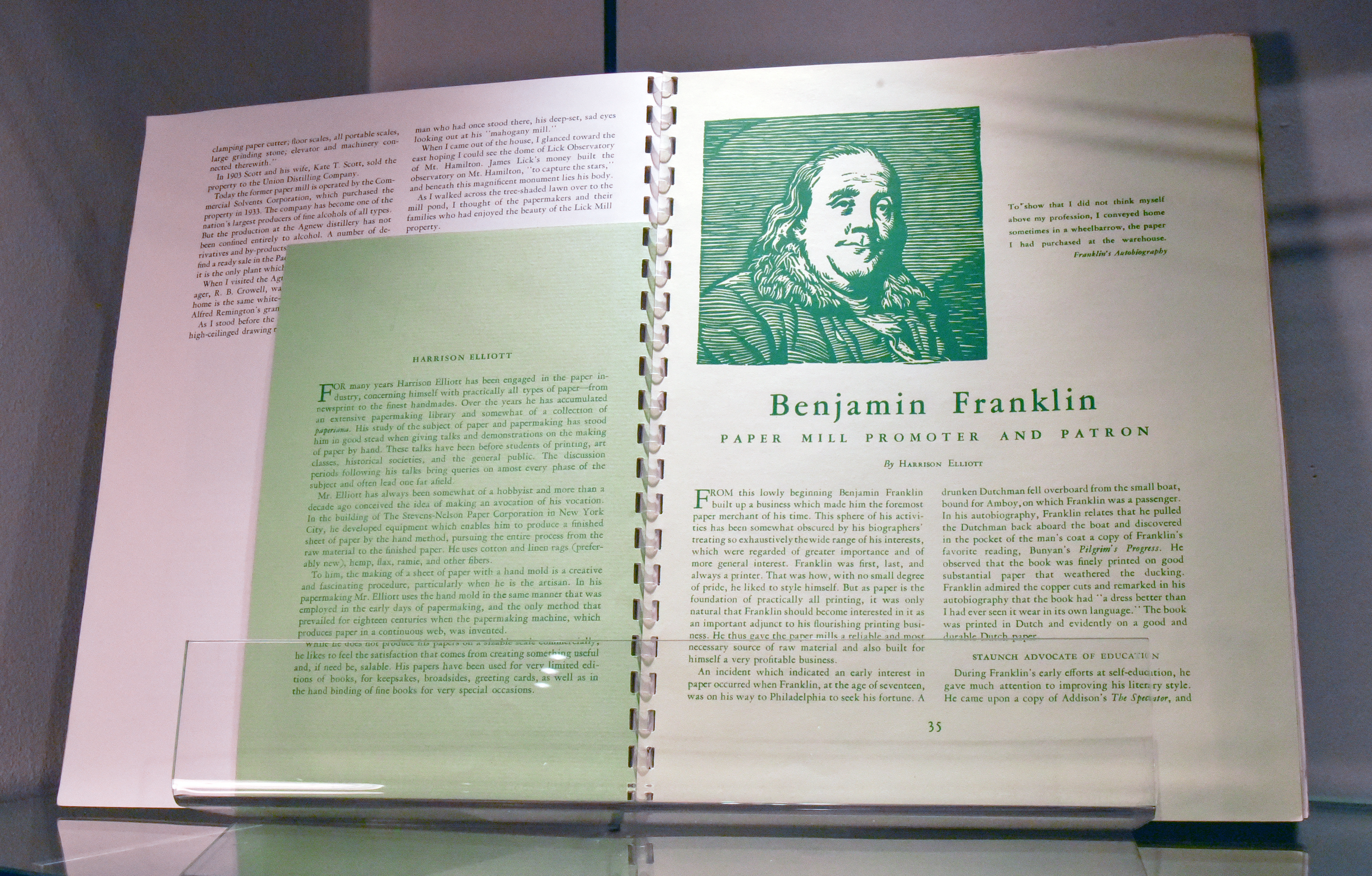 An edition of The Paper Maker open to an article titled "Benjamin Franklin: Paper Mill Promoter and Patron" written by Harrison Elliot. There is also a small green paper that gives a brief background of Harrison Elliot and his work.