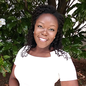 Head shot of Allyssa A. Lewis, Executive Director of animation staffing agency, My Animation Life. She is an African-American woman smiling, wearing a white dress and standing in front of a magnolia tree.