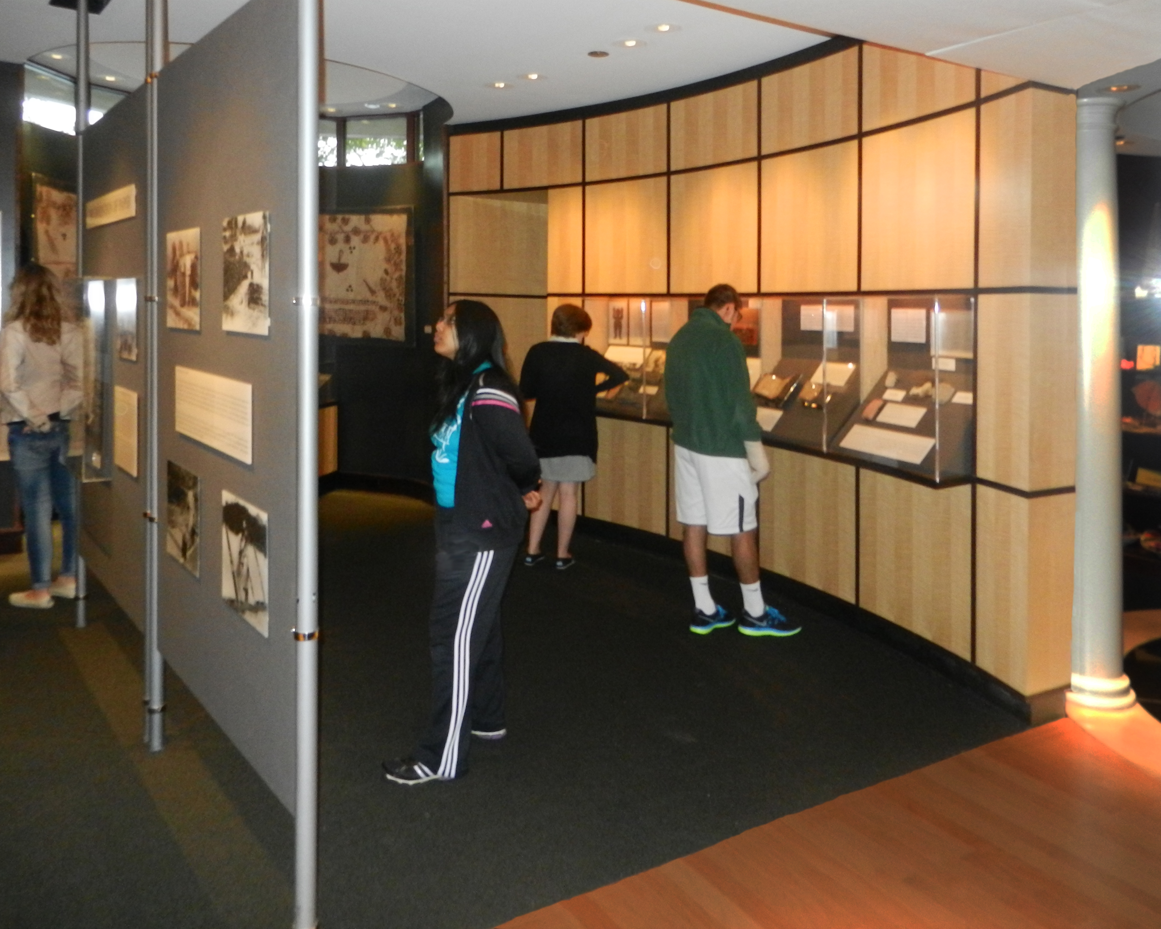 Visitors looking at display cases in the Robert C. Williams Museum of Papermaking