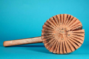 Wooden Mallet with grooves carved from the center out to create a textured surface