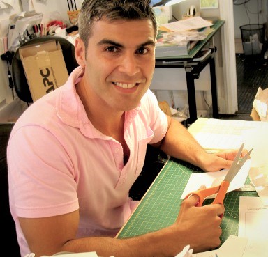Paper Engineer, Mathew Reinhart, sitting at his desk cutting a pop-up mock-up