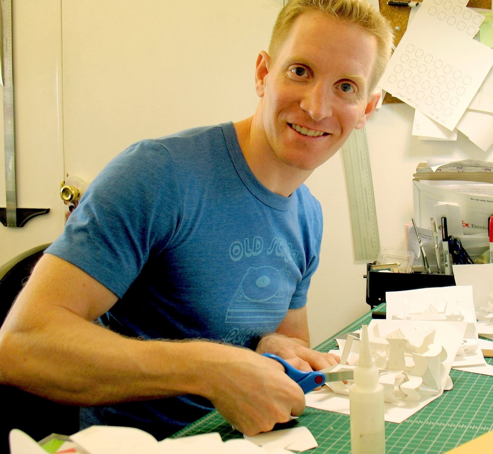Paper Engineer, Robert Sabuda, sitting at his desk cutting a pop-up mock-up
