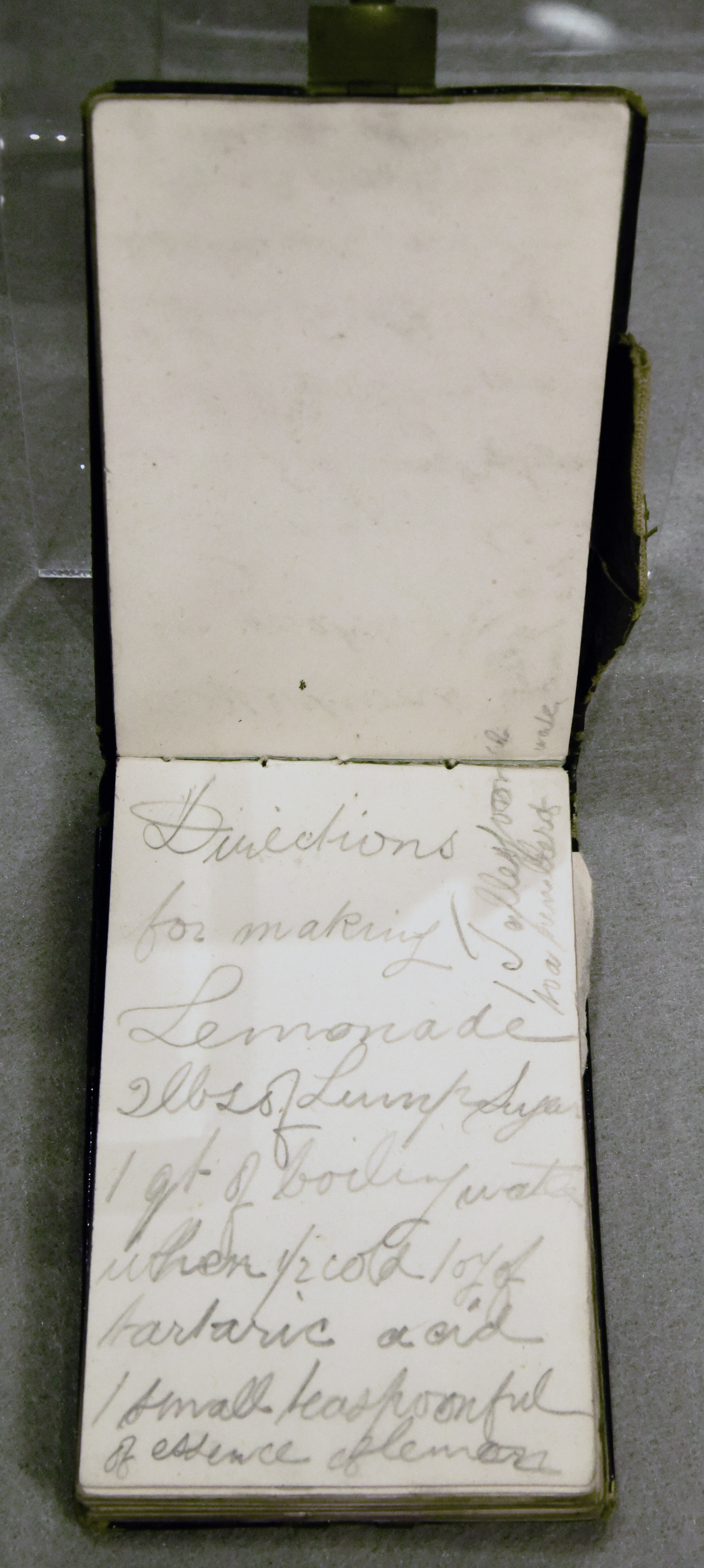 Leather-bound notebook with metal clasp, and a sleeve for a small pencil or pen. Elliott has written in the book so that the cover flips up rather than to the side.