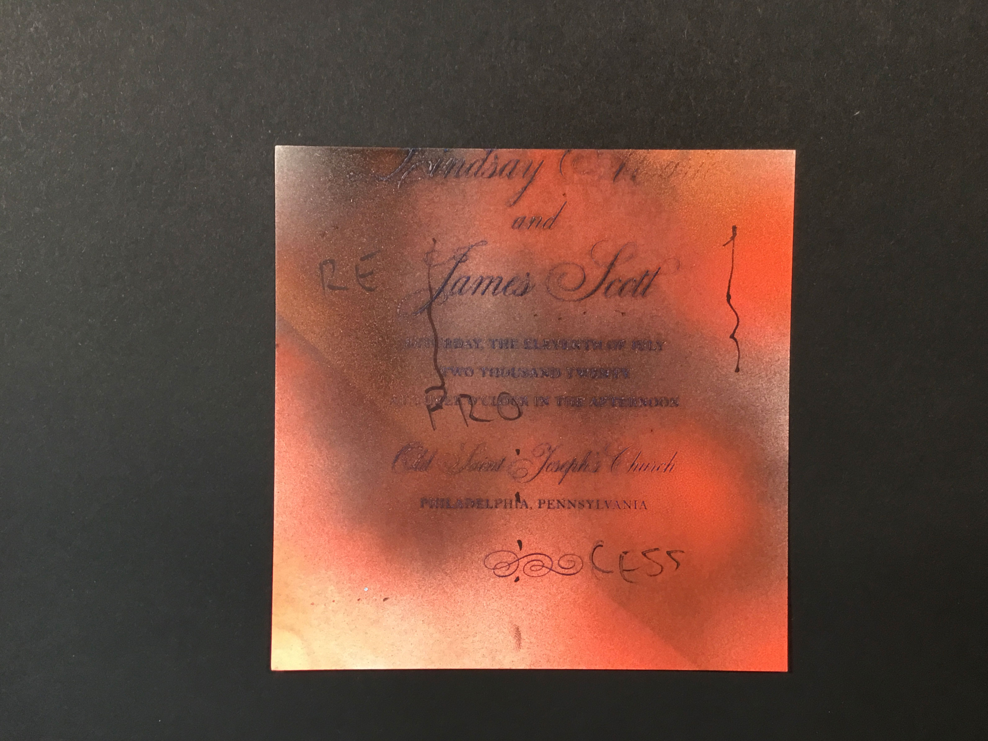 Red, black, and orange spray painted onto a wedding invitation with the word “Reprocess” written across the piece diagonally in black ink. 