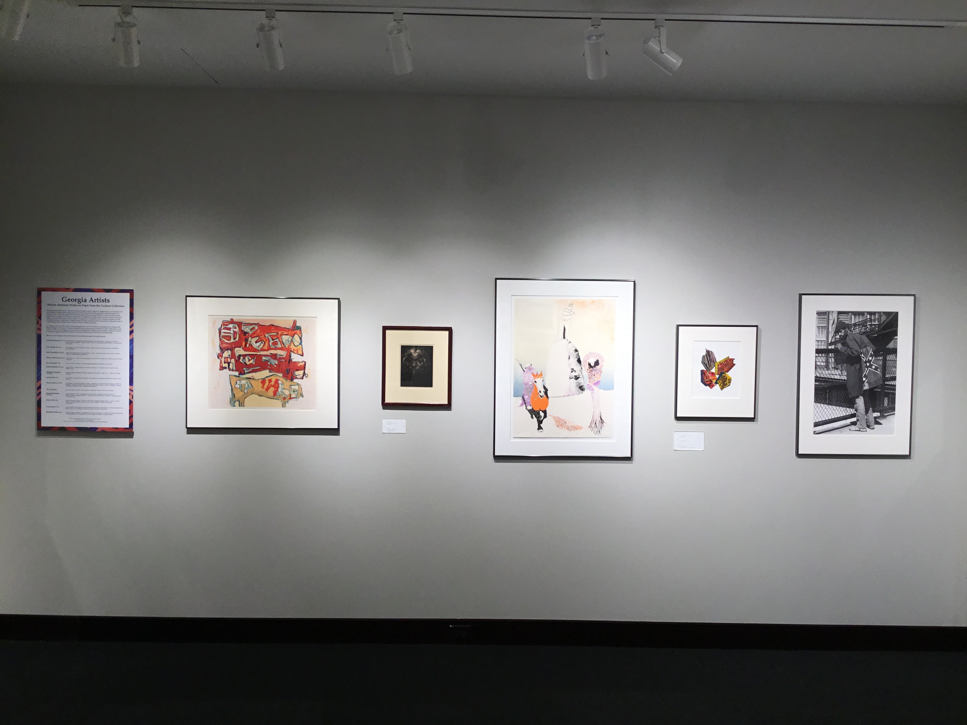 An image of the “Georgia Artists” section of the main gallery, with a placard explaining the lives of the artists on the far left, and five pieces of art from said “Georgia Artists” on the right.