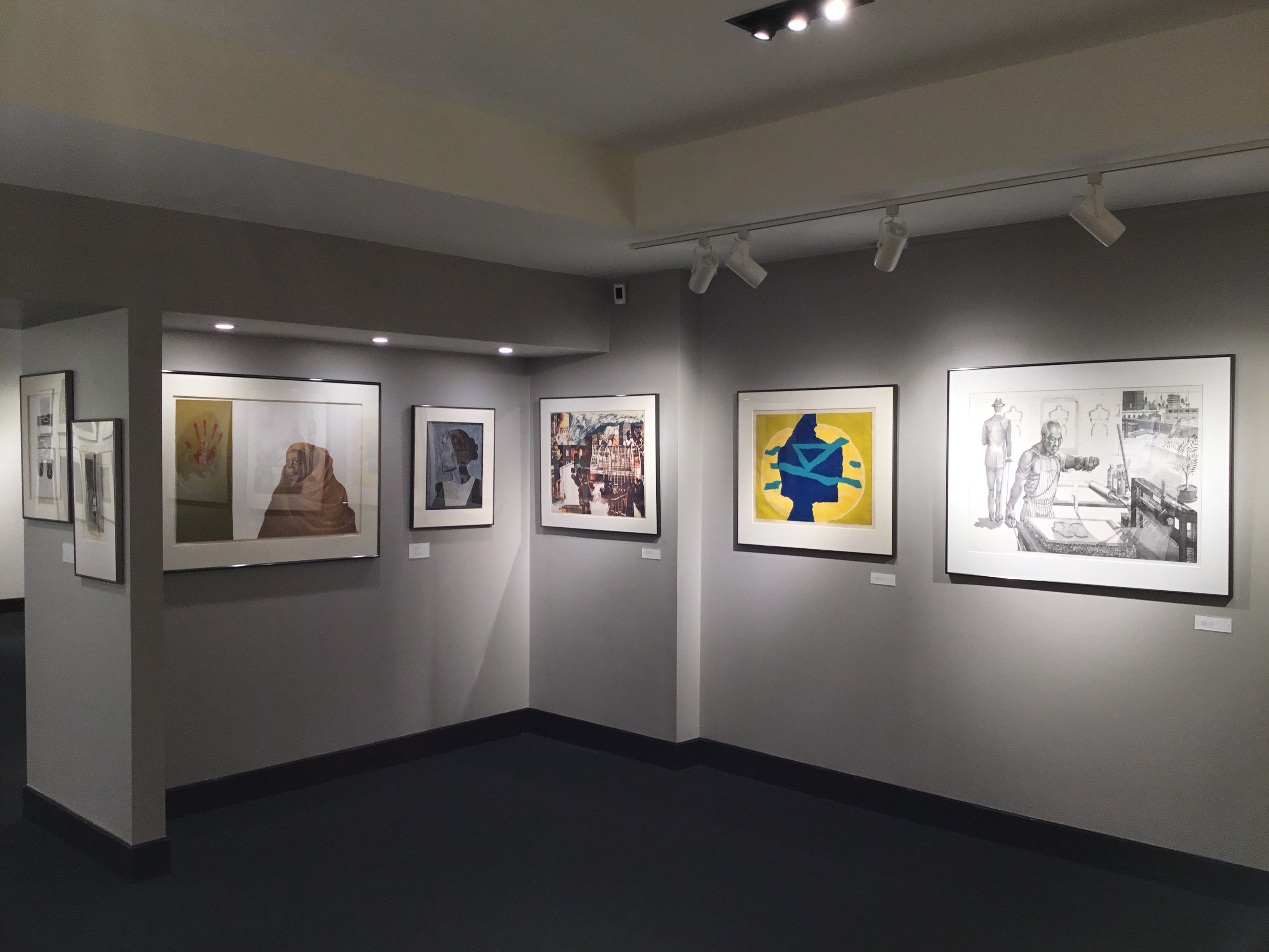 An image of the front corner of the second gallery, featuring five framed prints. 
