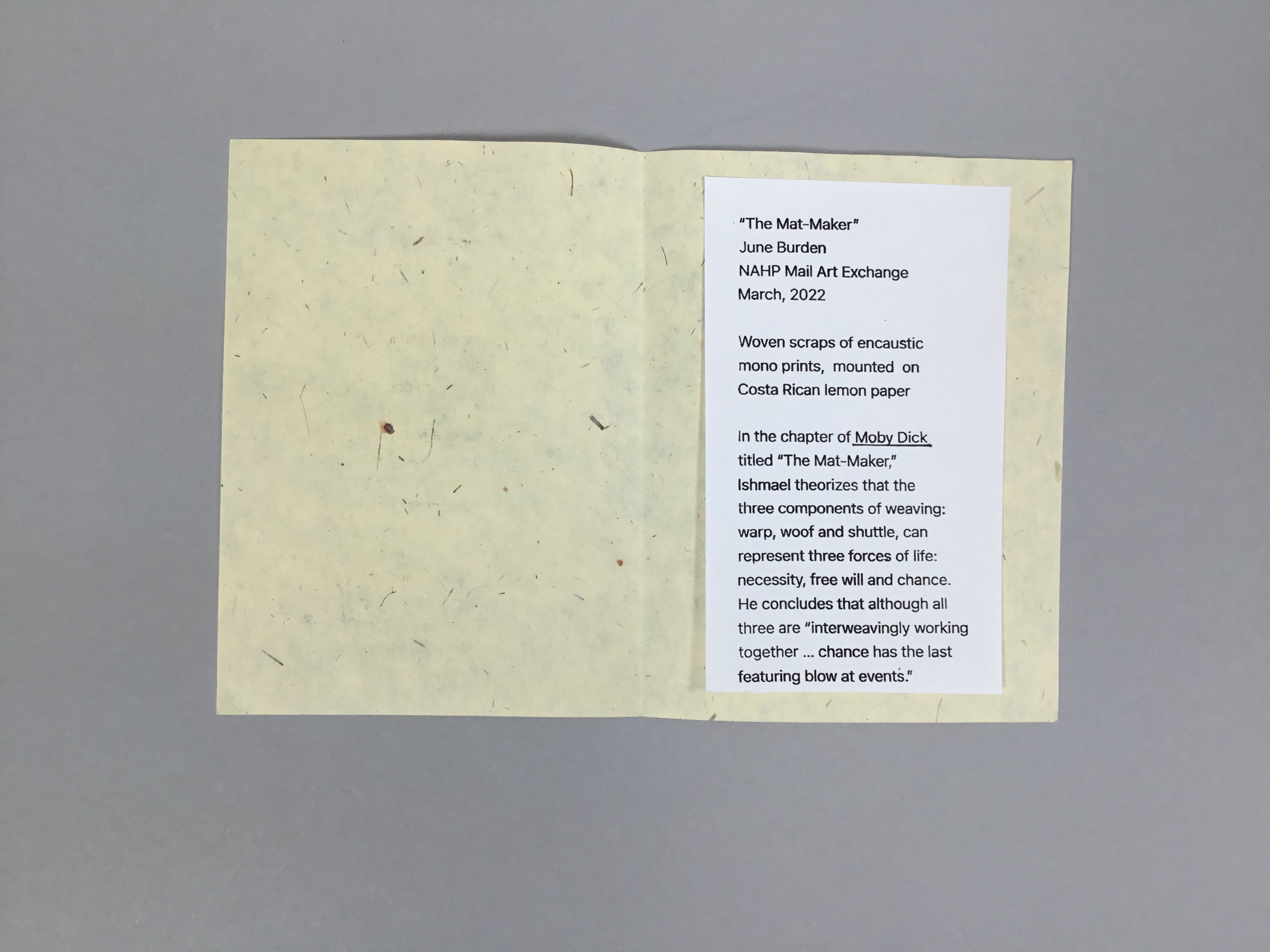 This card-like piece is made of a pale yellow Costa Rican lemon paper with a square piece of interwoven white, blue, yellow, and green scraps of paper on the front.