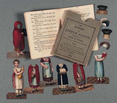 "The History of Little Fanny" is displayed with a little pamphlet book, a slipcover, 7 paperdoll bodies on removable Little Fanny head and four hats.