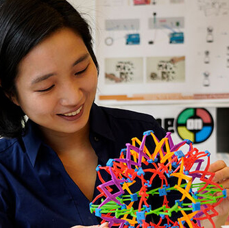 Photo of Hyun Joo Oh playing with a colorful spherical model