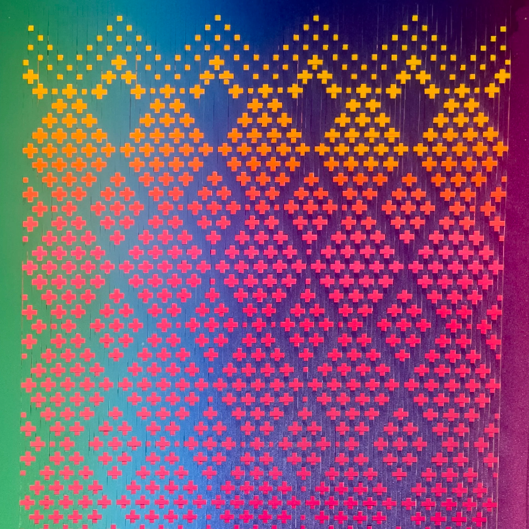  close-up view of a brightly colored paper weaving; Innervision by skye tafoya. 