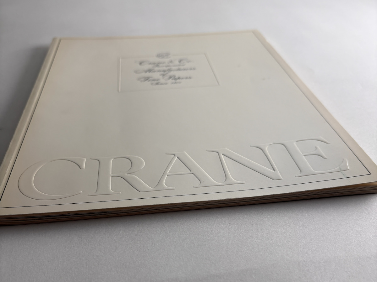 A book with raised letters spelling Crane near the bottom of the cover
