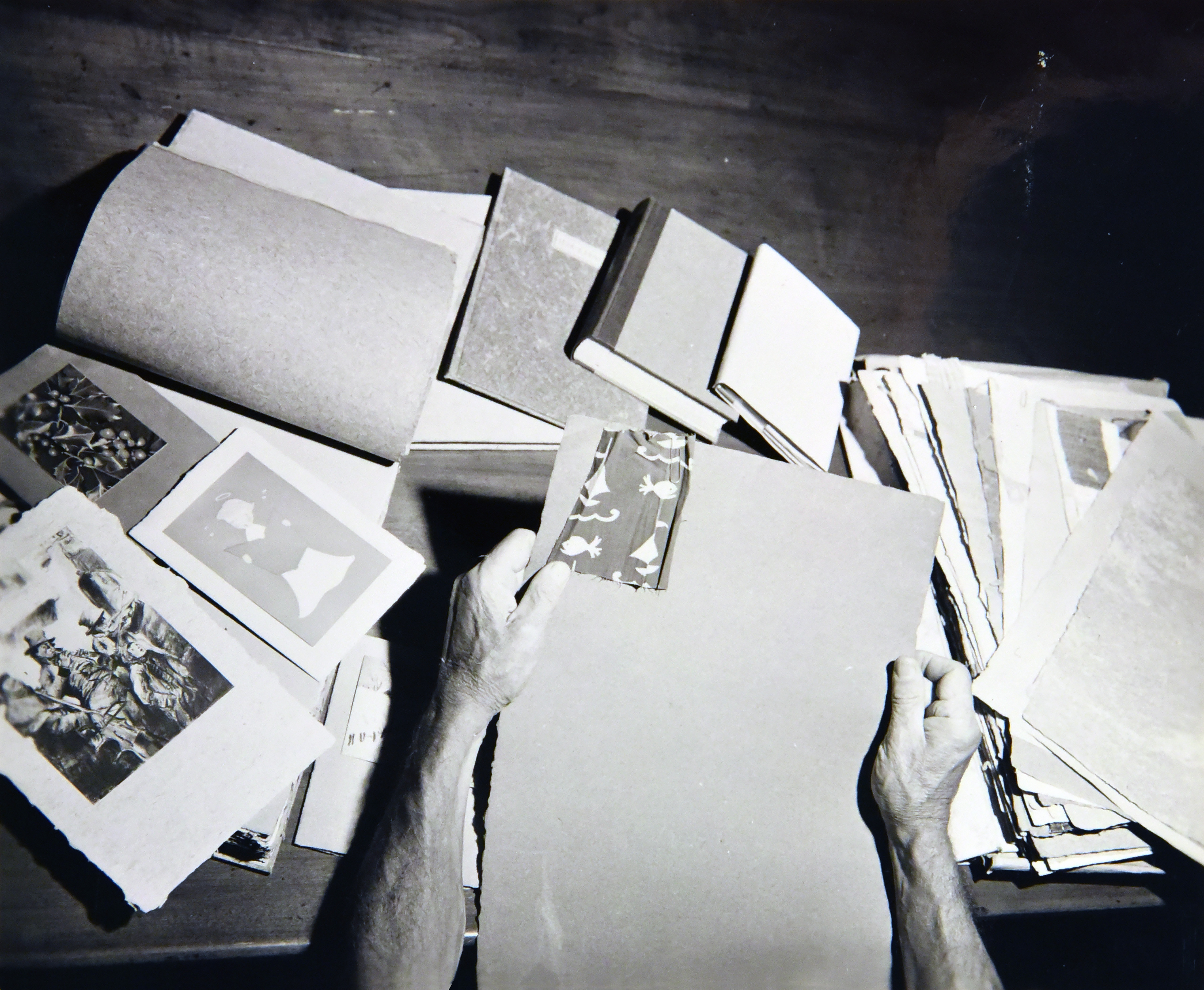 Black and white photograph of scattered handmade paper created by Harrison Elliot