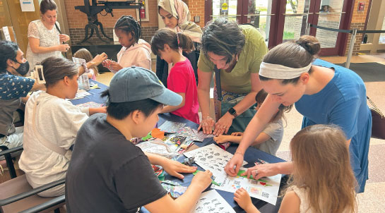 Group of people folding origami during family day