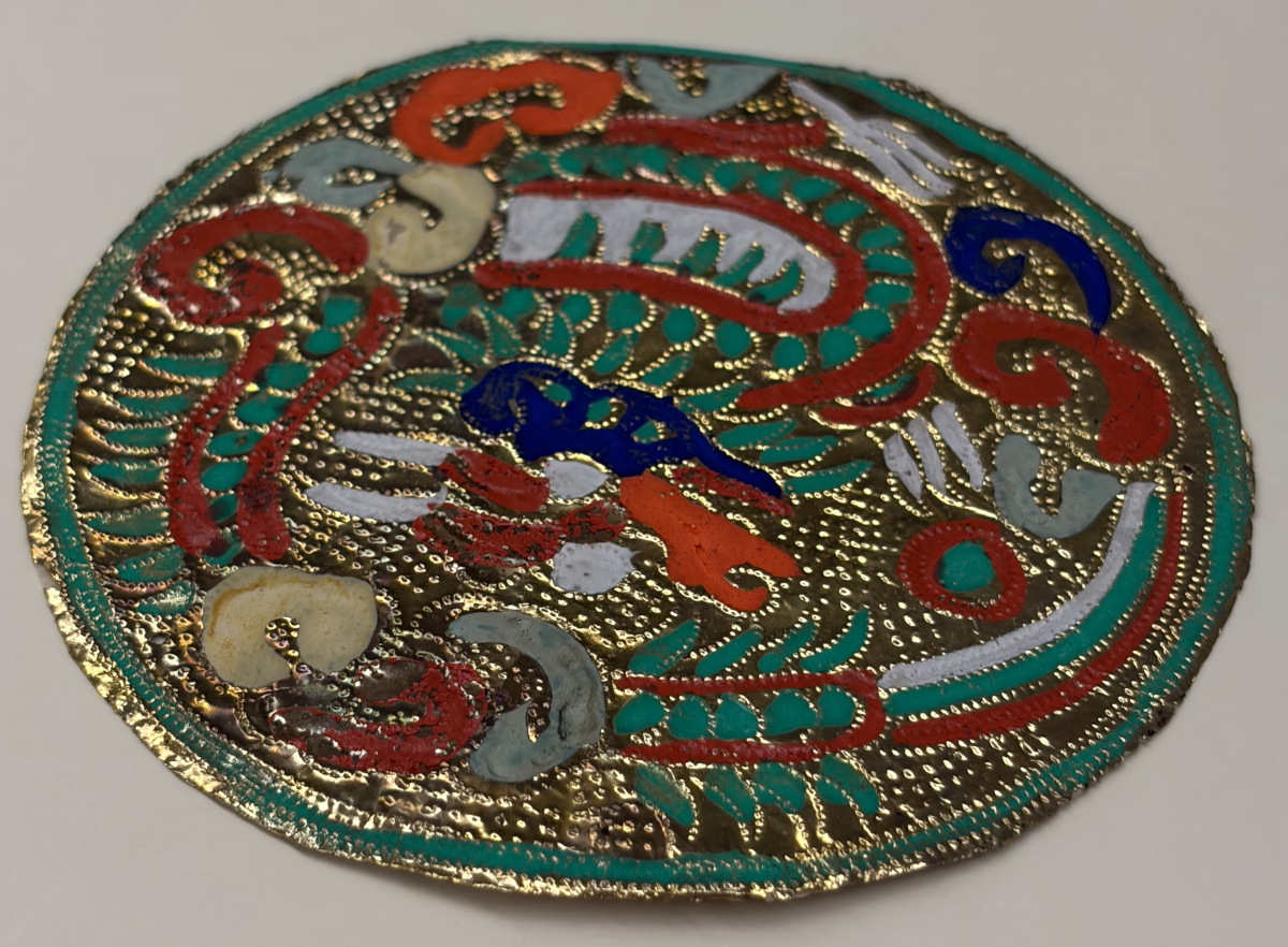 Vibrantly colored embossed foil in the shape of a circle.