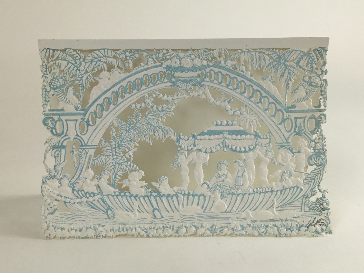 Full shot of the blue and white greeting card that shows all of the details and the shadows created by the die cut method.