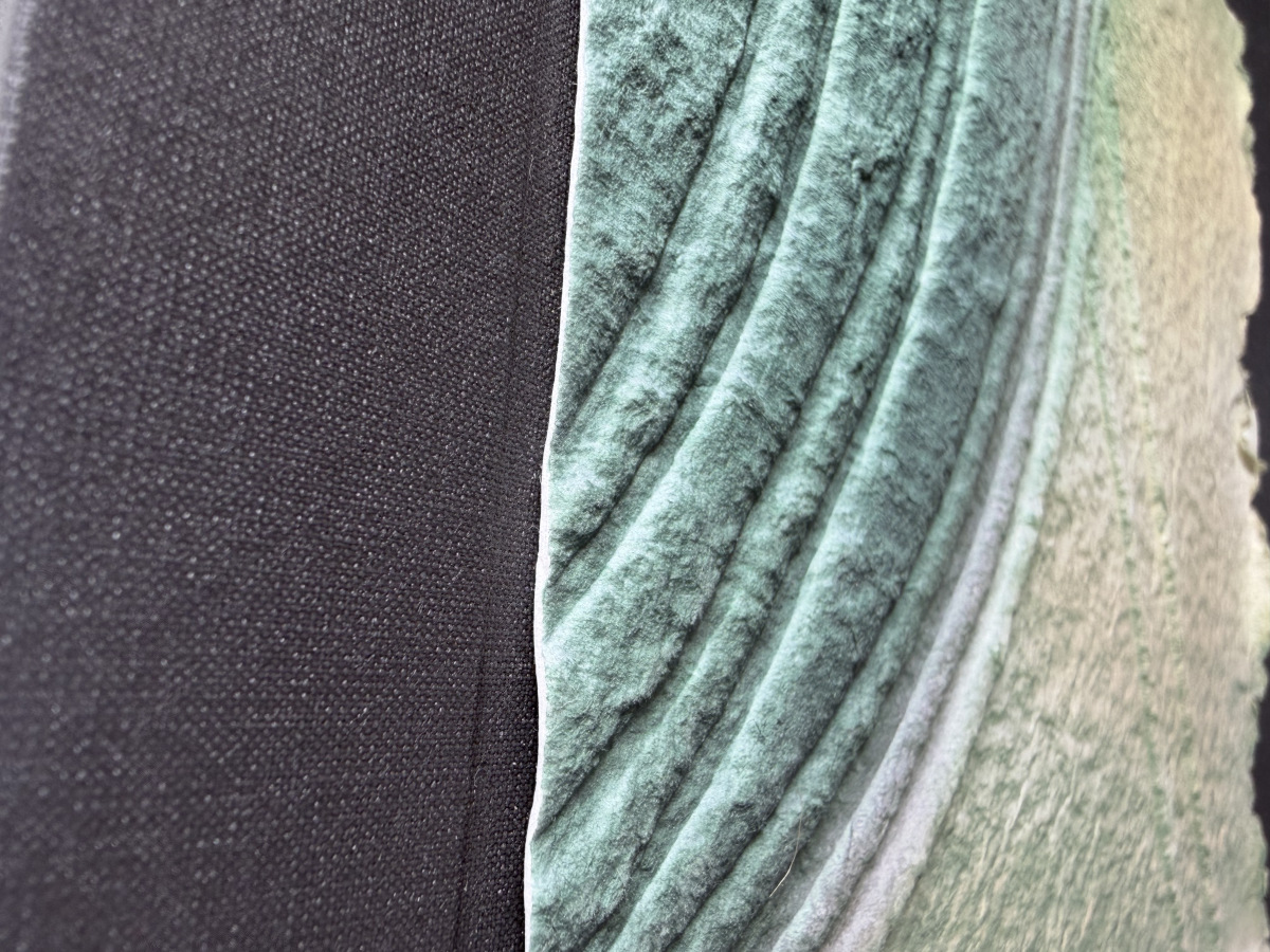 Close-up detail shot of the side of the box. This shot shows the raised shapes created by the green cotton sheet.