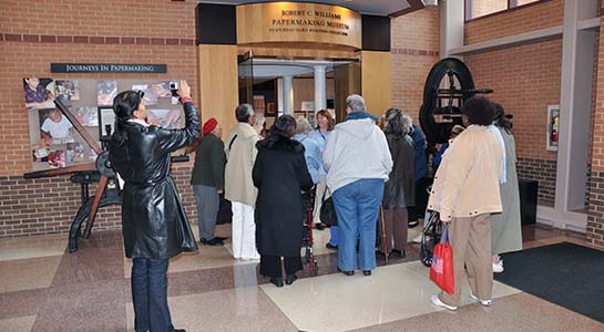 Adults heading into the Robert C. Williams Museum of Papermaking for a tour