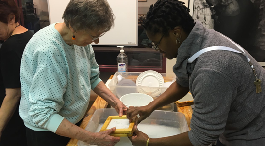 Adult making paper