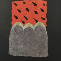 This piece of rectangular handmade paper is divided into two halves. The top half has a red background and black tear-drop shapes scattered across it, resembling a watermelon. The bottom half is plain gray, with three arches on the top, bordered with green paper.