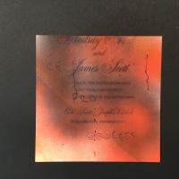Red, black, and orange spray painted onto a wedding invitation with the word “Reprocess” written across the piece diagonally in black ink. 