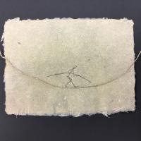 This piece is a horizontal sheet of translucent beige paper make from bleached, overbeaten flax. In the center of the sheet is a 2D “tightrope” made from hand-twined linen thread with a hand drawn stick figure tightrope walker “walking” on the thread.