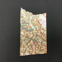 A rectangular sheet of brown, green, pink, and navy pigments with a large cut-out raw edge on the top of the piece. The paper, made from abaca and kozo, was created using a pulp-spraying technique. The back of the paper is light pink flecked with shades of purple and yellow.