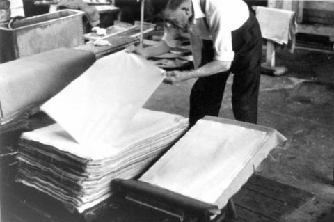 An IPST member removing sheets of paper from felts
