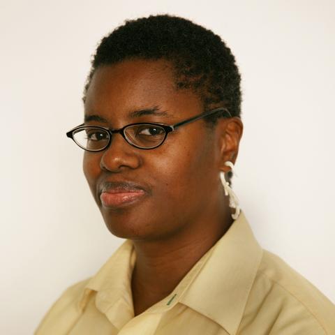 Photo of Jerushia Graham, an African American woman wearing glasses and a yellow button shirt with buzz cut hair
