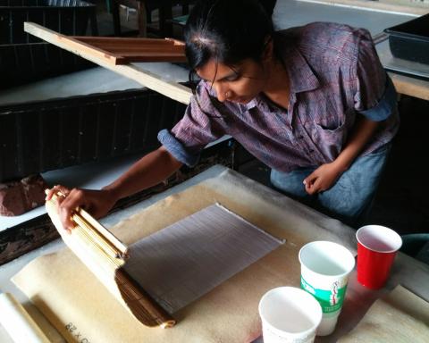 Photo of Radha Pandey making paper