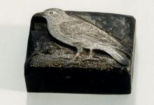 Image of the woodblock with a white substance brushed over it to reveal the intricate details in the bird's feathers