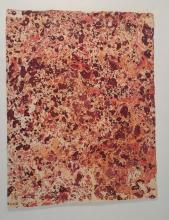 A sheet of red and orange marbled paper